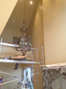Brandon Installing the light fixture in the family room - Eagle's Nest Estate